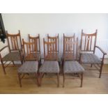 A good set of eight oak Arts and Craft dining chairs including two carvers in the style of Charles