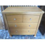 An oak effect four drawer chest by Izziwotnot, 90cm tall x 93cm x 54cm,