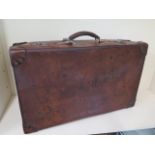 A vintage leather suitcase by Erskine and Son Ltd, 71cm x 43cm x 21cm, in polished usable condition
