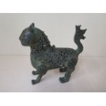 A metal leopard censor with green patinated finish, 17cm tall x 18cm long