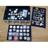 A collection of commemorative and other coins in a carry case