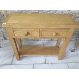 An oak two drawer side table, 85cm wide
