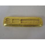 A gilt metal trade weight, 9.5cm long