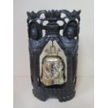 An Oriental temple bell in a carved wooden mount, 41cm tall x 24cm wide, some minor losses to