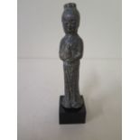 A metal figure on stand with aged patinated finish, 13cm tall