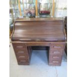 An oak roll top eight drawer desk with two slides in generally sound condition, some usage marks but