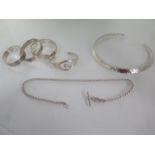 A silver necklet, four silver bangles and a silver watch chain 45cm long, total weight approx 5.5