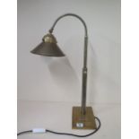 A brass adjustable desk lamp in working order