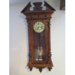 An 8 day twin weight striking walnut wall clock, 130cm tall x 55cm wide in working order