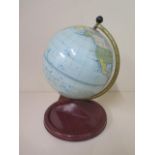 A tin plate Chad Valley 7" terrestial globe, 11" tall, in good condition