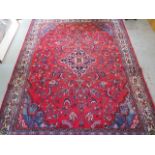 A hand woven full pile Persian Surok woollen village rug with floral medallion design, 290cm x