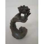 A bronze hand and flower with patinated finish, 7cm long