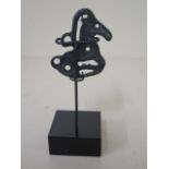 A metal figure on stand, 11cm tall, with patinated finish