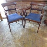 A pair of restored Regency Mahogany scroll open armchairs
