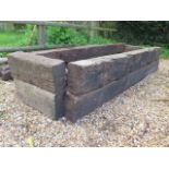 A garden planter made from reclaimed railway sleepers, 227cm long x 50cm tall x 50cm wide,