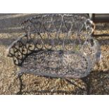 A weathered cast iron decorative garden bench, 94cm wide