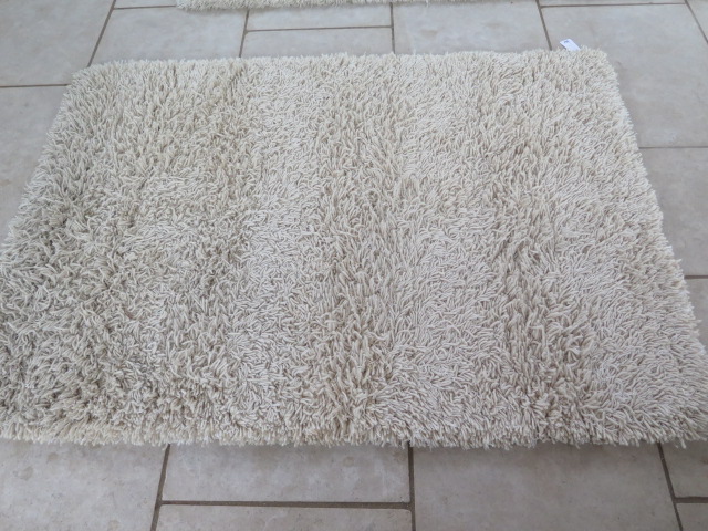 A modern shag pile rug, 140cm x 200cm, by the Real Rug Company, in good condition