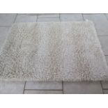 A modern shag pile rug, 140cm x 200cm, by the Real Rug Company, in good condition