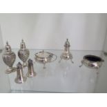 A silver three piece cruet set, London 1963/64, a pair of embossed silver peppers, a silver salt and