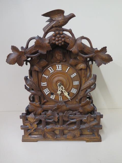 An unusual Cuckoo carved mantle clock, 46cm tall, in generally good condition, running order,