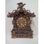 An unusual Cuckoo carved mantle clock, 46cm tall, in generally good condition, running order,