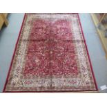 A rich red ground full pile Tree of Life design rug with a cream border, 109cm x 104cm in good