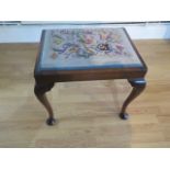A mahogany stool with cabriole legs, needlework seat, some wear to needlepoint otherwise good,