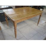 A Victorian stripped pine kitchen table on turned legs, 76cm tall x 137cm x 89cm