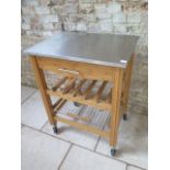 A kitchen workstation with a stainless steel top on wheels, 70cm wide x 50cm deep