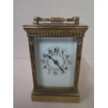 An 8 day French carriage clock strikes hours / half hours, the case decorated with inlaid ceramic