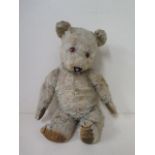 A vintage mohair teddy bear with boot button eyes in play worn condition, 48cm tall