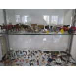 A large collection of Britains and other lead figures including cowboys, farm animals, buildings and