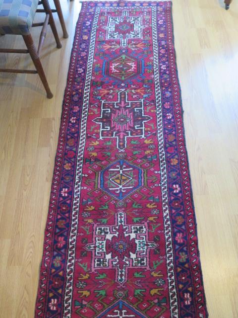 A hand knotted woollen runner with a red field, generally good condition, 340cm x 66cm - Image 3 of 4