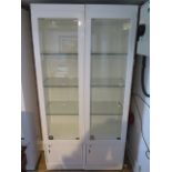 A pair of good quality shop display cabinets with electric lighting and slam shut locks, each