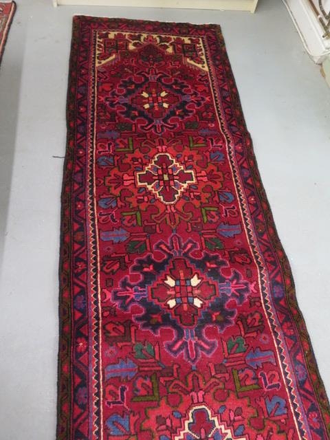 A hand woven vintage Persian Heriz runner with medallion design in vibrant colours, 310cm x 83cm - Image 3 of 4