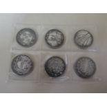 Six white metal eastern coin tokens
