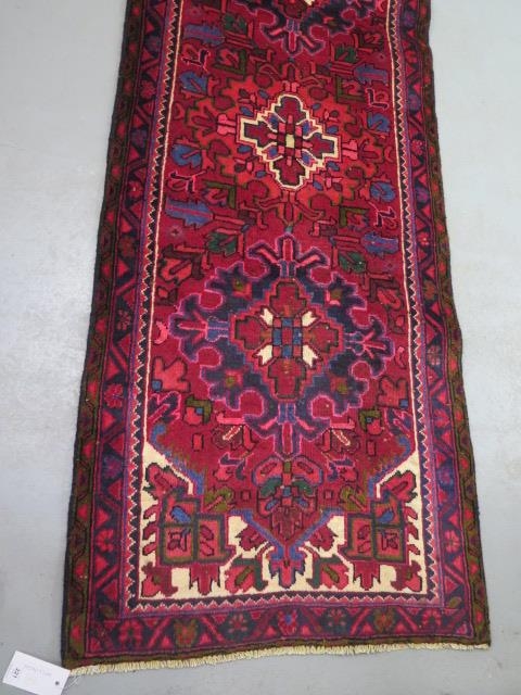 A hand woven vintage Persian Heriz runner with medallion design in vibrant colours, 310cm x 83cm - Image 2 of 4