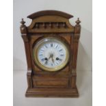 A walnut 8 day French mantle clock with ceramic dial, striking on a bell, 29cm tall, in good