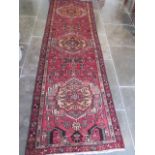 A hand knotted woollen runner rug, 290cm x 88cm, generally good condition