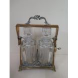 A brass two bottle tantalus Scotch and Rye, 32cm tall x 23cm wide, scotch decanter has been