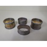 Two pairs of silver napkin rings, approx 4 troy oz, one pair engraved