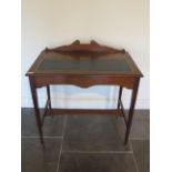 A nice Edwardian writing desk with boxwood and stringing inlay, tapered legs with brass castors,