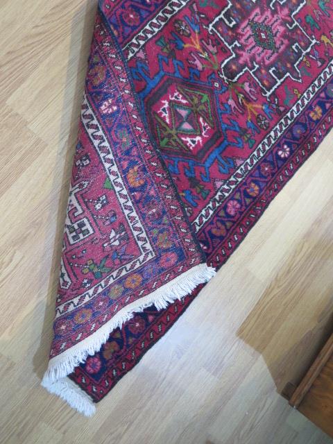 A hand knotted woollen runner with a red field, generally good condition, 340cm x 66cm - Image 4 of 4