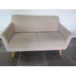 An oatmeal two seater sofa, 77cm tall x 144cm x 84cm