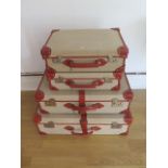 A set of four Papworth Industries canvas fibre and leather suitcases, largest 22cm x 72cm x 49cm,