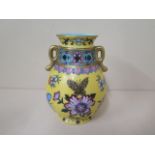 A yellow ground famille rose twin handle vase, 14cm tall, in good condition and signed to base