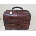 A Victorian crocodile skin Gladstone travel case by Drew and Sons, London, with a new paisley fitted