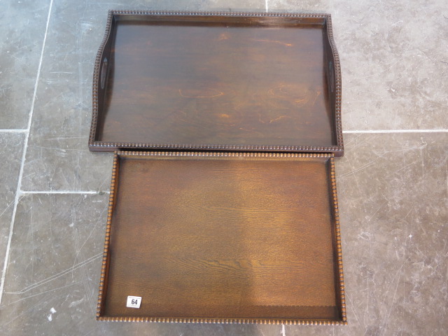 Two 1930's oak tea trays, longest 60cm x 40cm