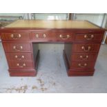 A good quality Victorian style eight drawer mahogany twin pedestal desk with a leather insert top