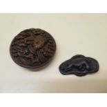 A carved wooden Netsuke of a carp in waves, 7cm diameter and a carved wooden lizard on a sandal, 6cm